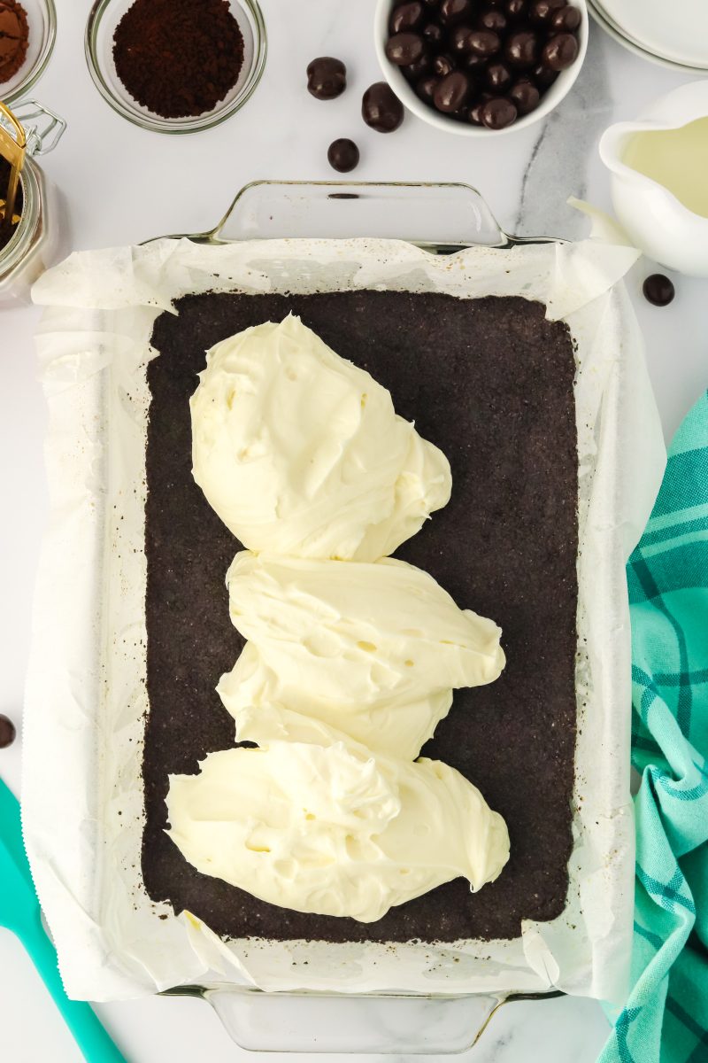 Creamy cheesecake filling dolloped over a chocolate Oreo crust - Hostess At Heart