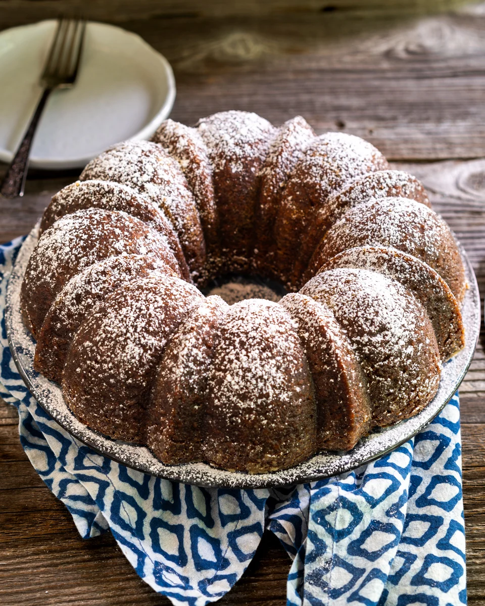 Angled top down view of a moist Cuban Rum Bundt Cake dusted with powdered sugar - Hostess At Heart