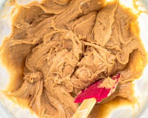 Cake batter that's thick like peanut butter in a mixing bowl - Hostess At Heart
