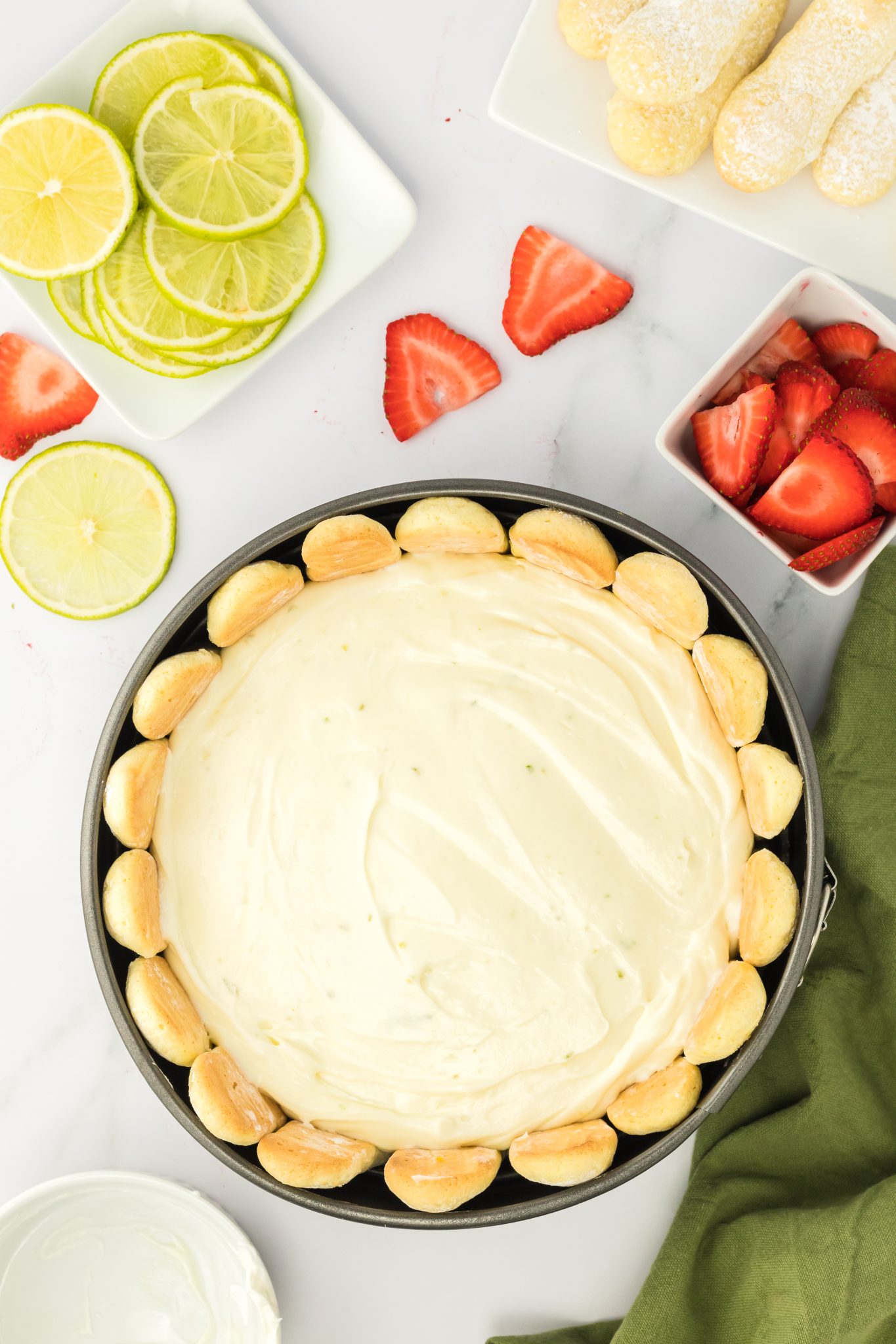 top down view of unbaked lime cheesecake in a pan ready to chill.