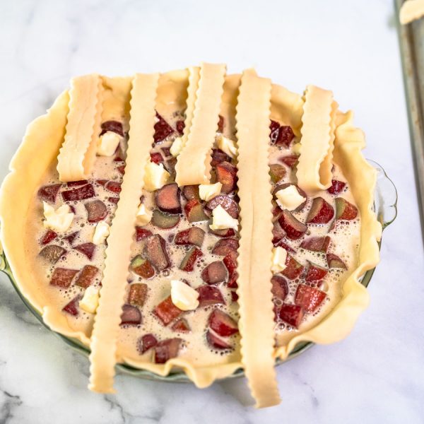 Strips of pie dough ran vertically across a custard filled pie to make a lattice crust. Hostess At Heart