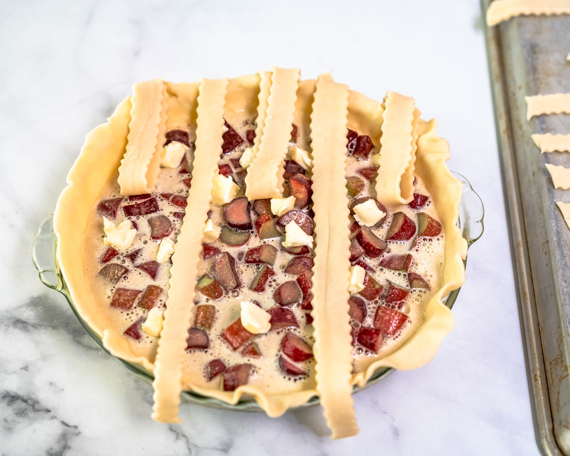 Strips of pie dough ran vertically across a custard filled pie to make a lattice crust. Hostess At Heart