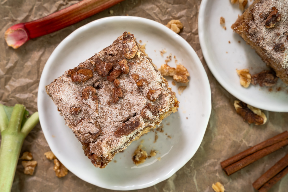 Top down view of a slice of cake topped with a crunchy sugar walnut topping - Hostess At Heart