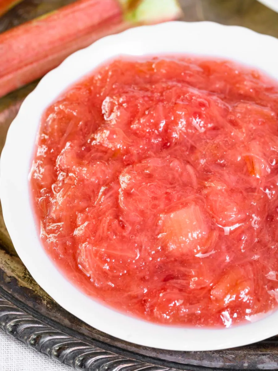 Closeup view of cooked rubarb sauce in a small white bowl - Hostess At Heart