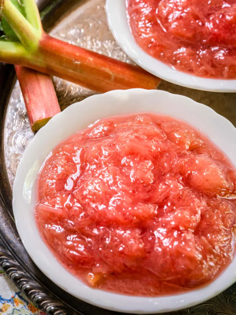 Closeup view of a white dish filled with homemade rhubarb sauce. Hostess At Heart