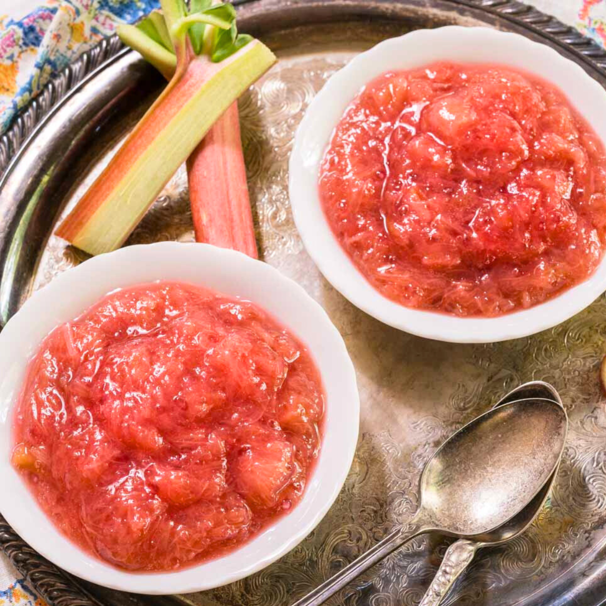 Angled view of two dishes filled with homemade rhubarb sauce. Hostess At Heart