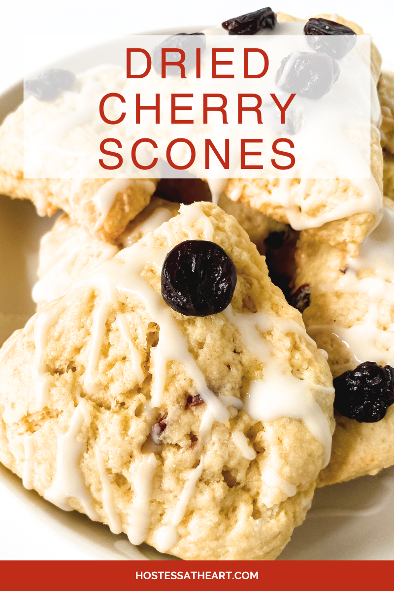 Angled view of homemade scones filled with dried cherries and topped with vanilla glaze - Hostess At Heart