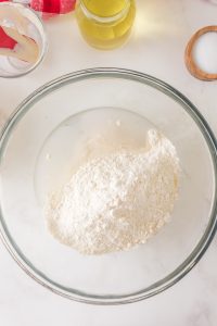 Flour added to sourdough starter and water to make sour dough pizza dough - Hostess At Heart