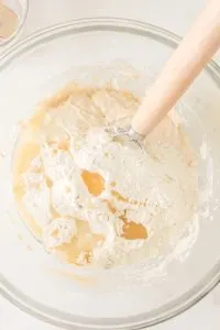 Mixing bowl filled with sourdough starter water and flour - Hostess At Heart