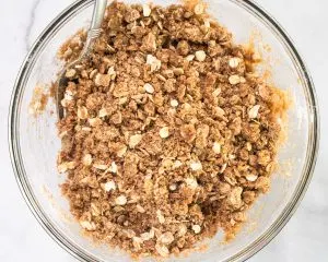 Top down view of a bowl filled with oat crumble topping - Hostess At Heart
