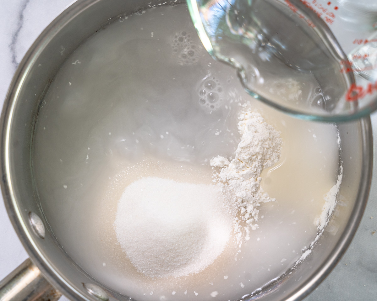 A saucepan filled with water, sugar, and cornstarch