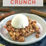 Angled view of a slice of rhubarb crisp topped with vanilla bean ice cream - Hostess At Heart