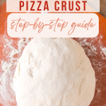Top down view of a ball of pizza dough sitting on a floured cutting board - Hostess At Heart
