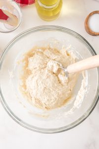 Sticky pizza crust dough in a mixing bowl - Hostess At Heart