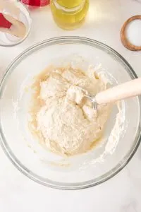 Sticky pizza crust dough in a mixing bowl - Hostess At Heart