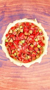 Strawberry Rhubarb Pie Filling loaded into a bottom crust. Hostess At Heart