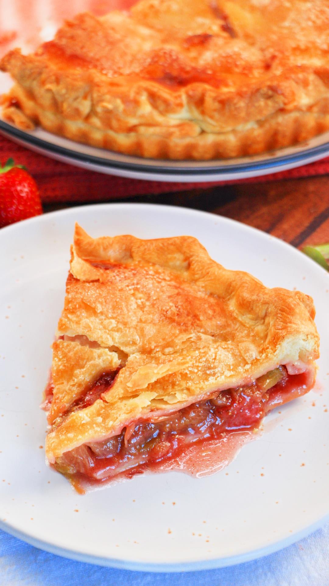 3/4 angle of a slice of rhubarb and strawberry pie on a plate - Hostess At Heart