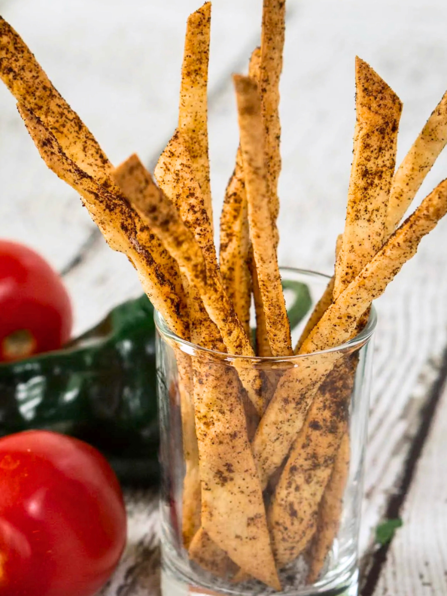 A small glass holding baked chili crusted tortilla strips - Hostess At Heart