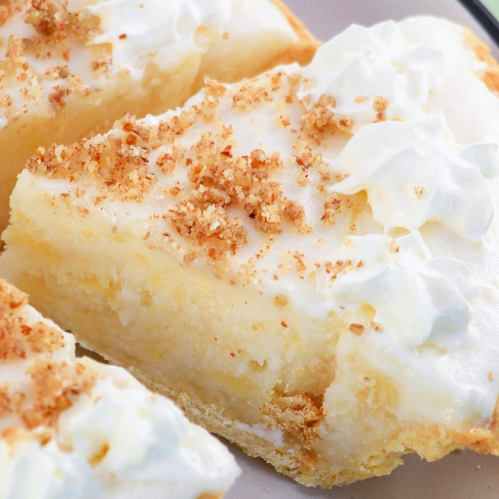 Close-up view of a slice of cream pie pulled away from the entire pie - hostess At Heart