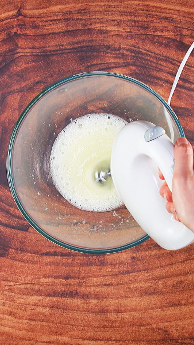 An electric mixer whipping egg whites in a bowl - Hostess At Heart