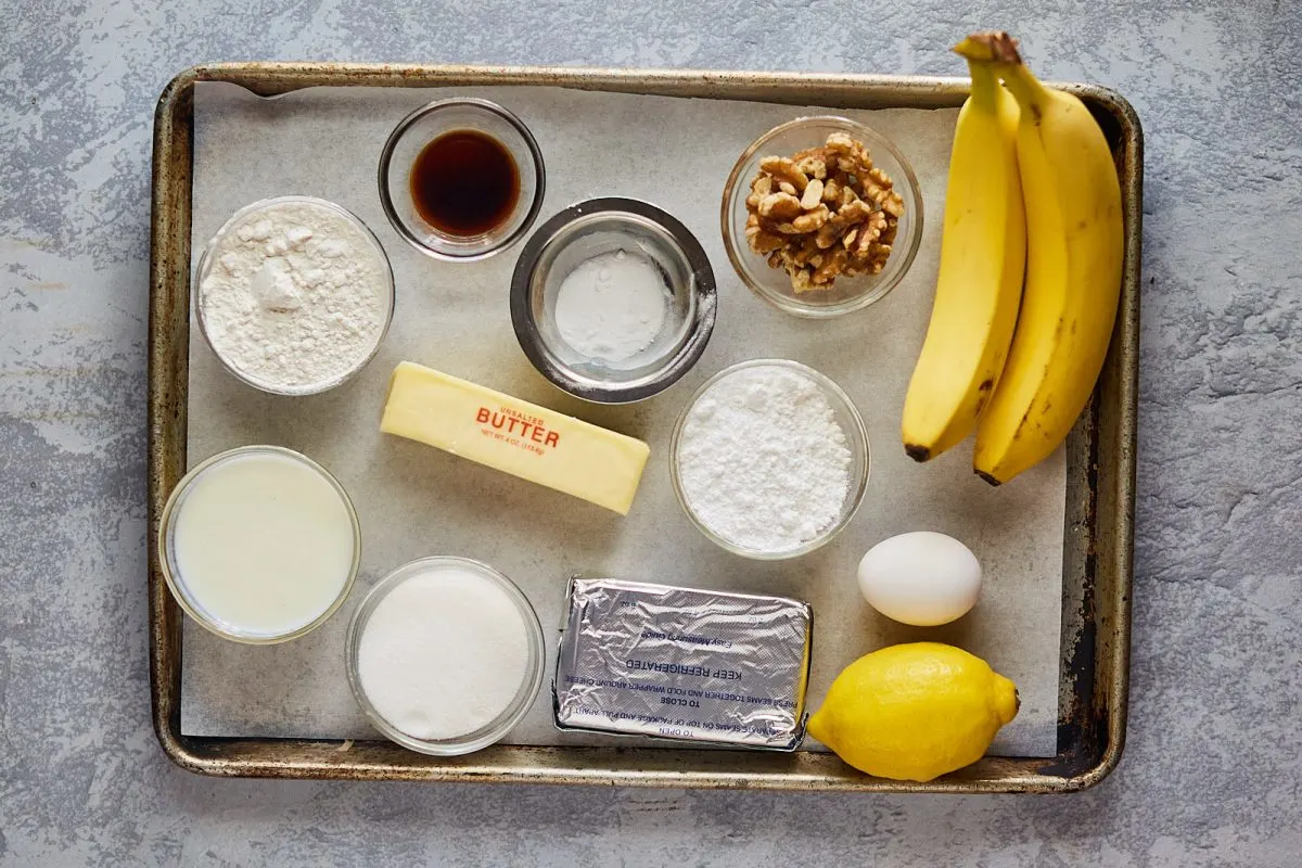 Ingredients for the Easy Recipe for Banana Cake: flour, vanilla, salt, baking soda, nuts, bananas, butter, egg, buttermilk, sugar, lemon. Hostess At Heart