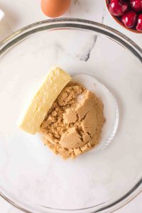 A stick of butter in a bowl with brown sugar and white sugar - Hostess At Heart