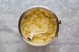 A mixing bowl filled with banana cake batter - Hostess At Heart