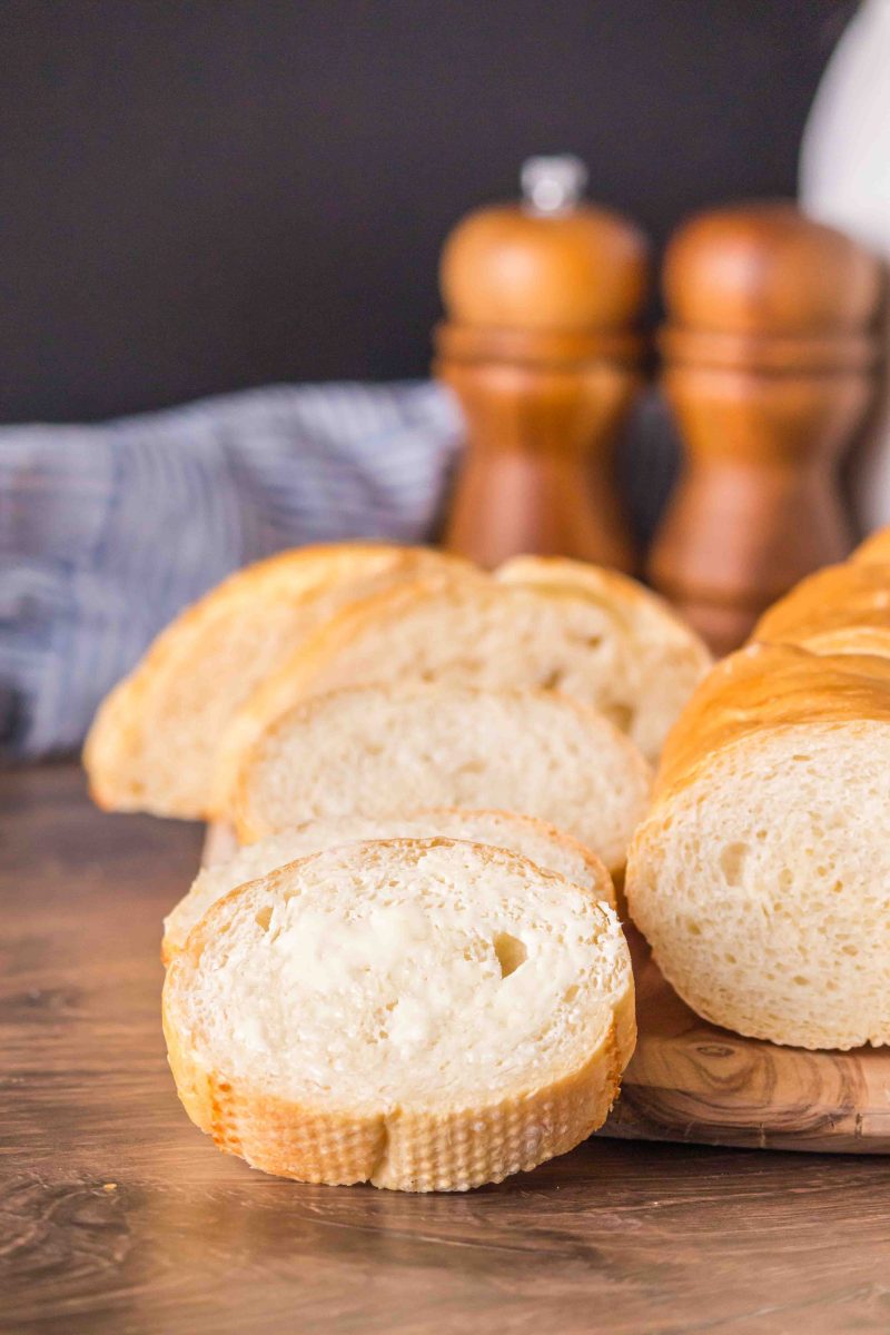 Close up tableview of sliced and buttered french baguette bread - Hostess At Heart