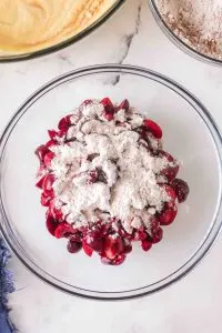 A bowl of fresh cherries dusted with flour in a mixing bowl - Hostess At Heart