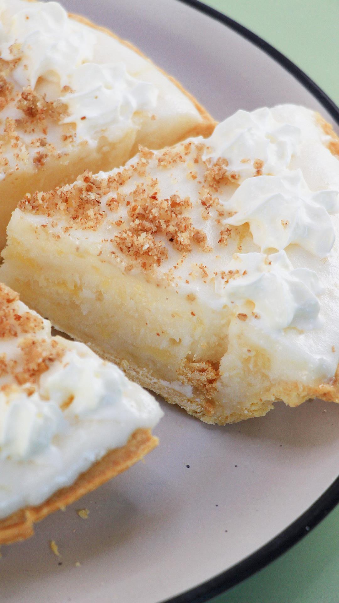 A slice removed from a creamy Angel Food pie topped with crushed nuts and whipped cream stars - Hostess At Heart