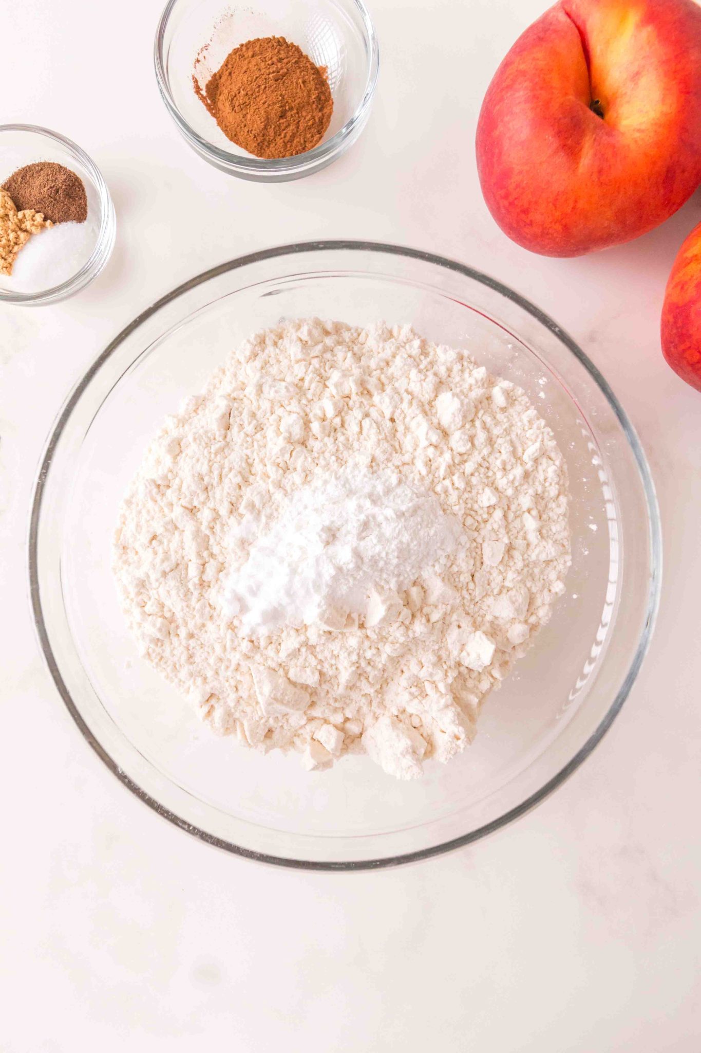 A mixing bowl containing flour, baking powder, and baking soda - Hostess At Heart