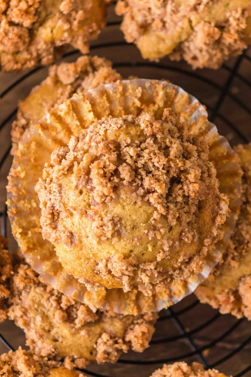 Closeup top down view of a baked peach muffin topped with cinnamon streusel - Hostess At Heart