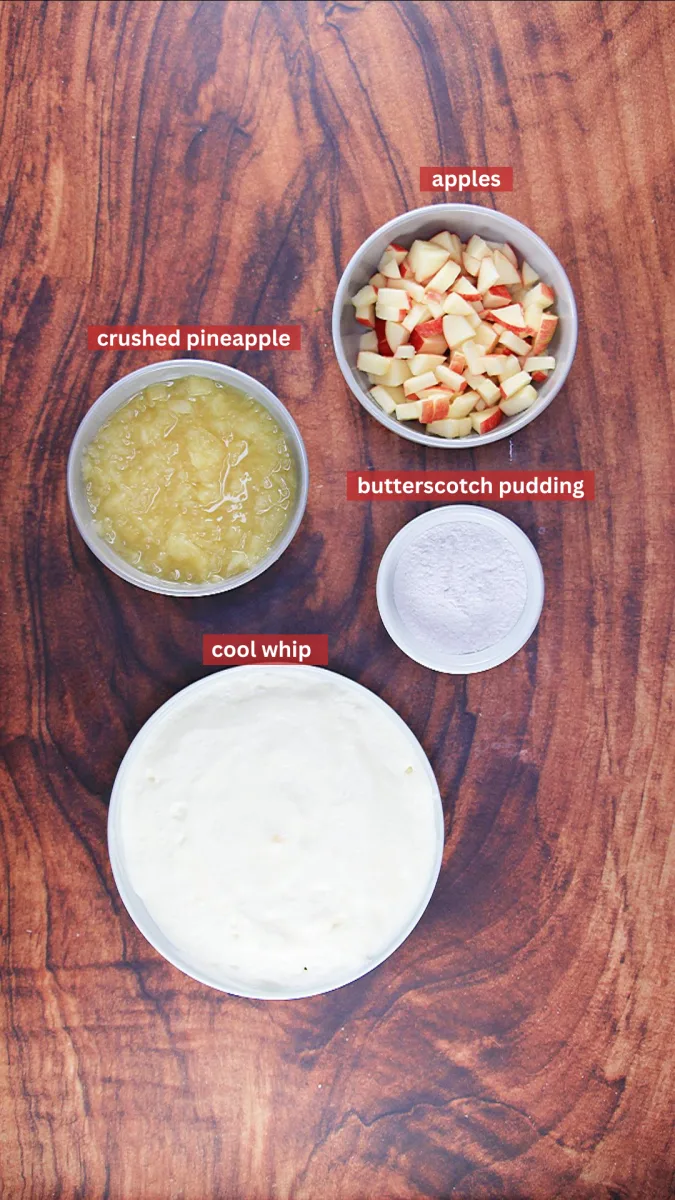 Ingredients used to make a caramel apple salad without snickers including Apples, crushed pineapple, butterscotch pudding, and Cool Whip - Hostess At Heart