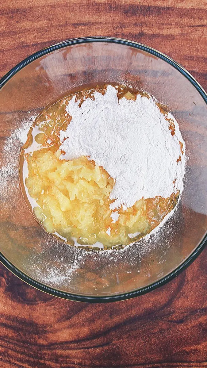 Top down view of a bowl filled with crushed pineapple and instant pudding mix - Hostess At Heart