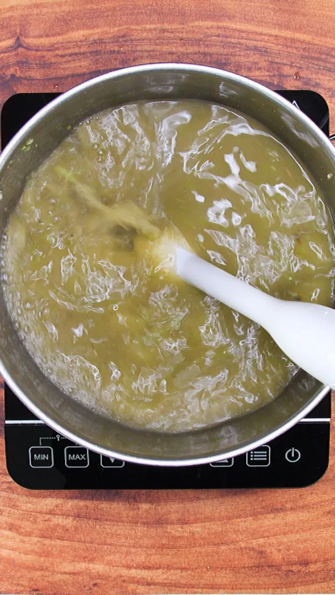 A stick immersion blender mixing up green peppers with tomatillos - Hostess At Heart