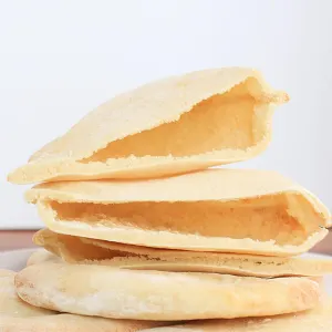 Front view of individual pita breads stacked on top of each other.