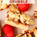 An image for Pinterest of sliced raspberry squares topped with crumble - Hostess At Heart