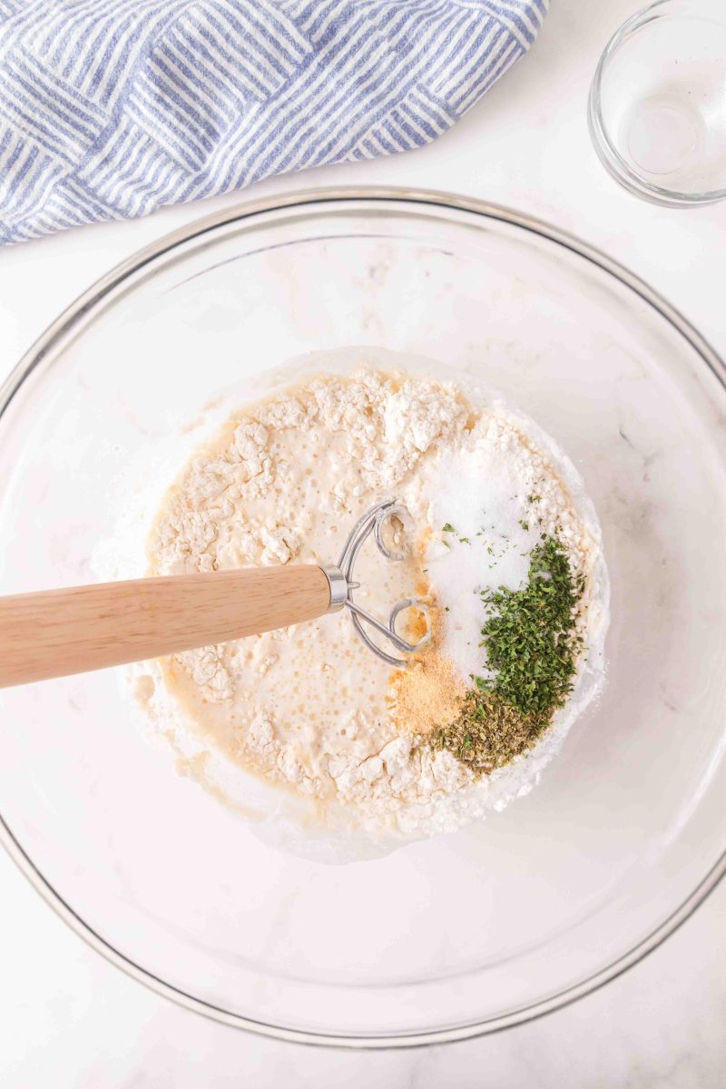 Adding the flour and seasonings to wet mixture using a Danish dough hook - Hostess At Heart