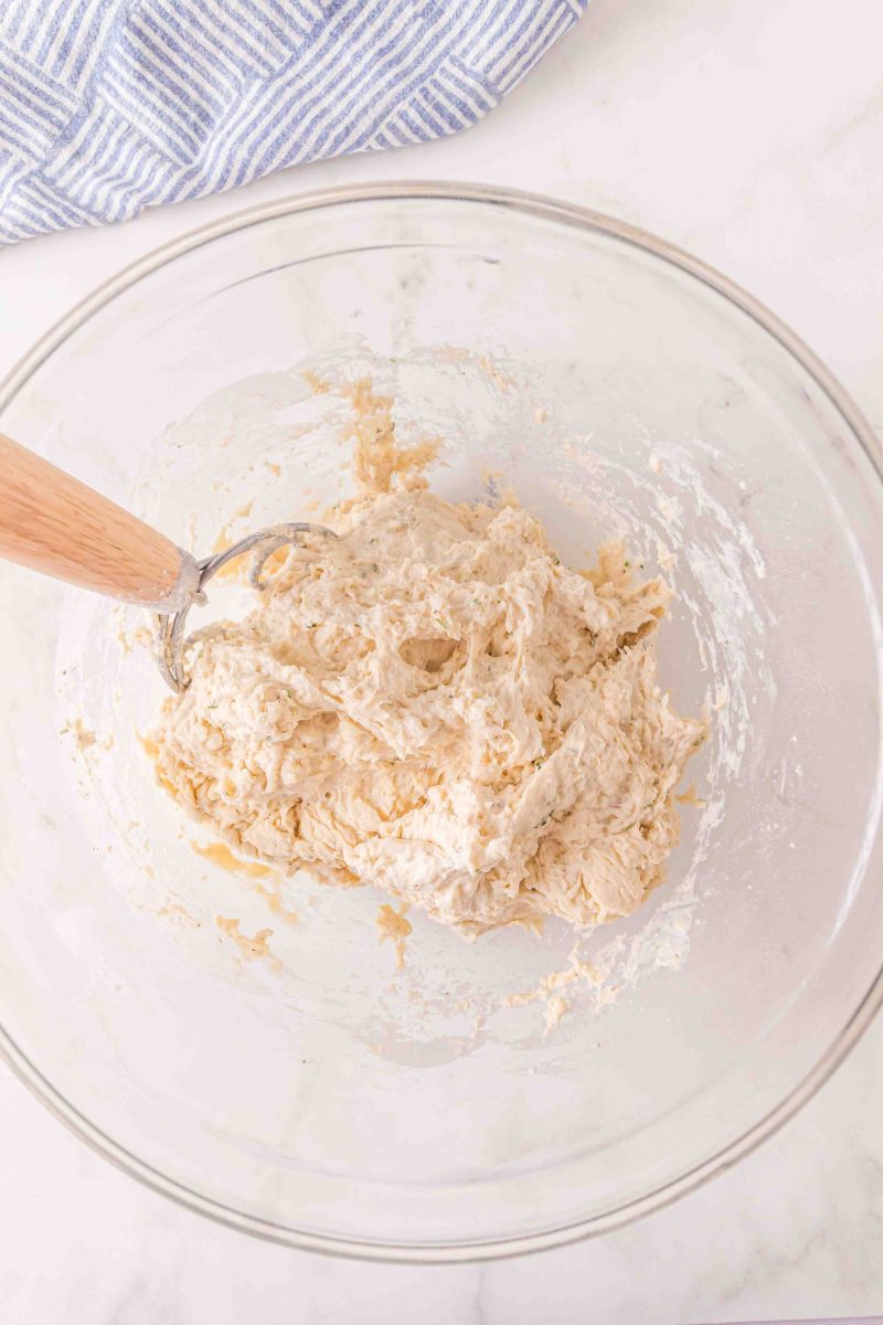 Stirring the dough with the Danish dough hook to fully incorporate the flour.