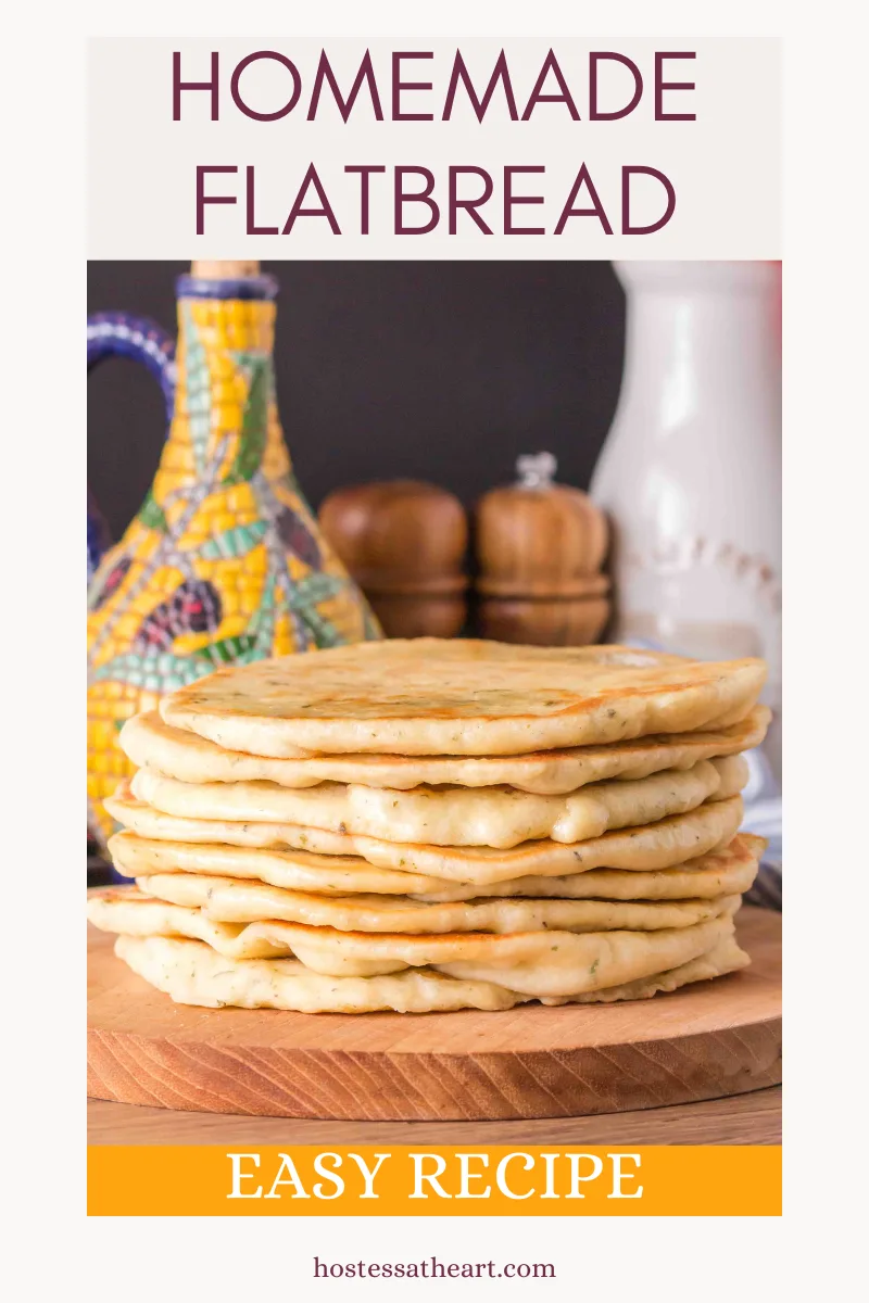 Sideview of homemade flat bread recipe sitting on a cutting board with an oil caraffe in the distance. Hostessatheart.com