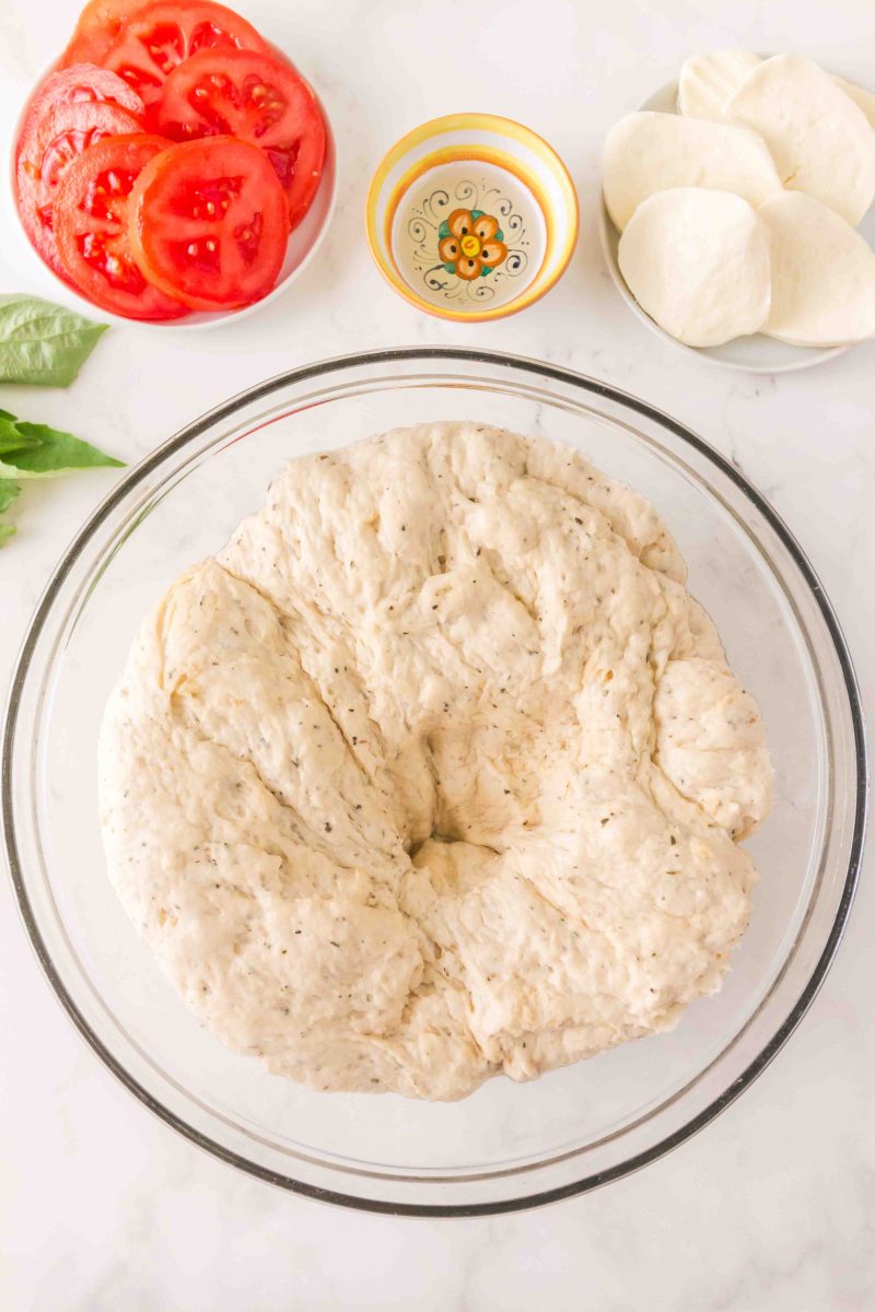 Punching down the dough before forming the crusts.