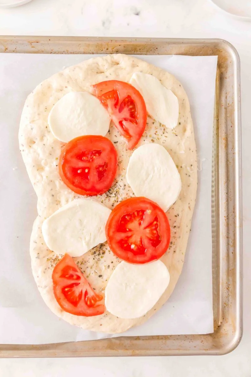 Adding the toppings for a Margherita Pizza. Hostess At Heart