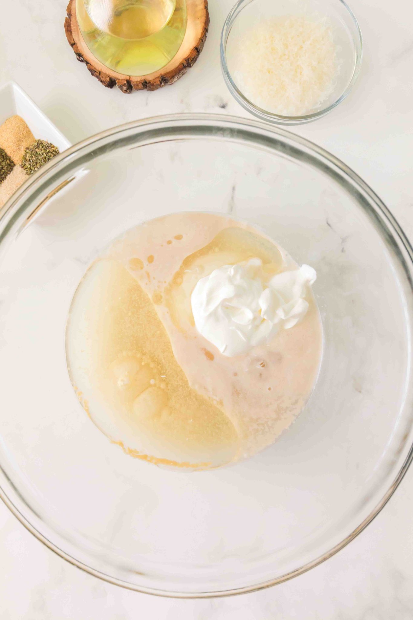 Adding the other liquid ingredients to the yeast in a mixing bowl. Hostess At Heart
