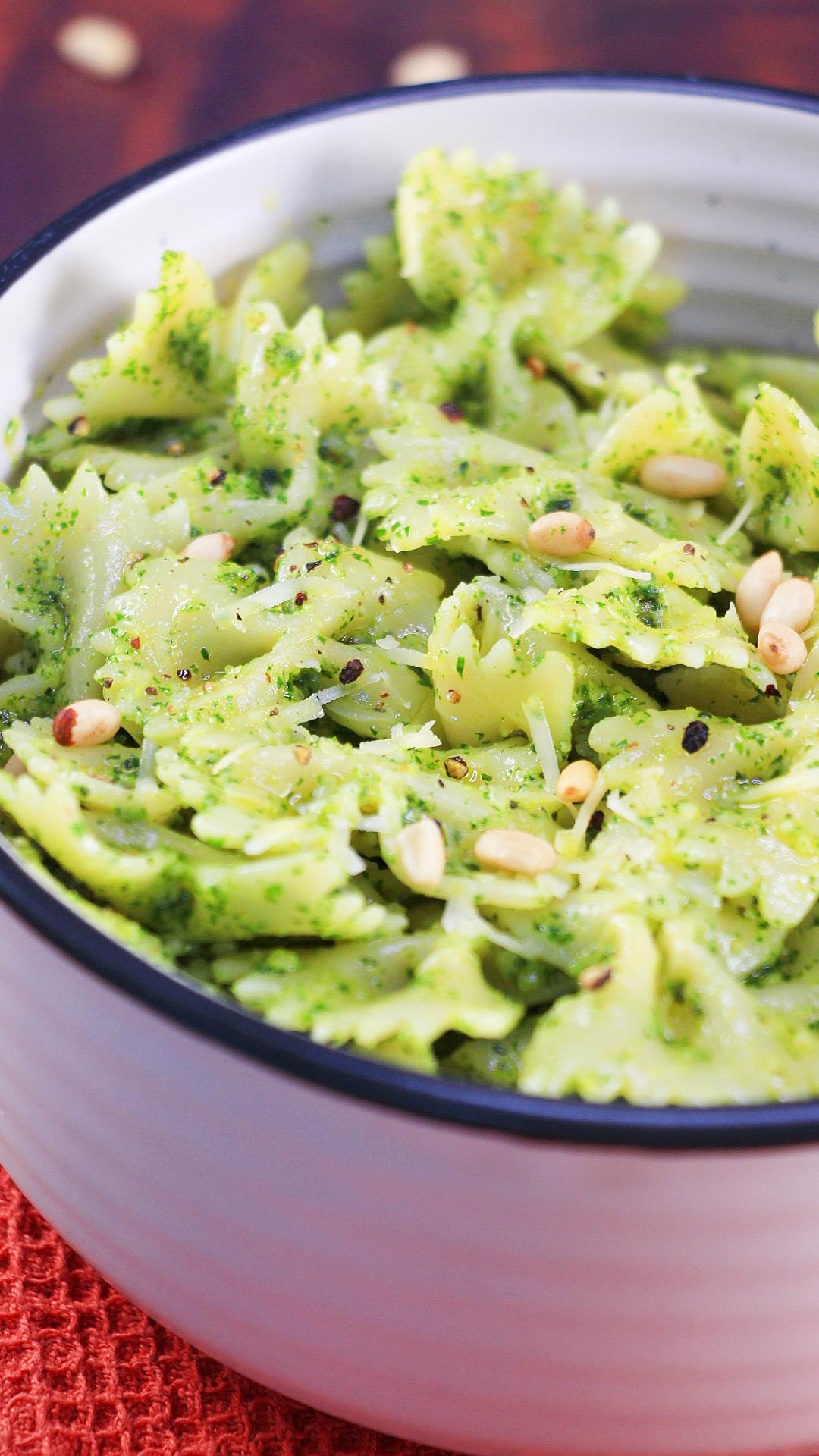 A bowl filled with pasta that's been blended with fresh basil pesto. Hostess At Heart