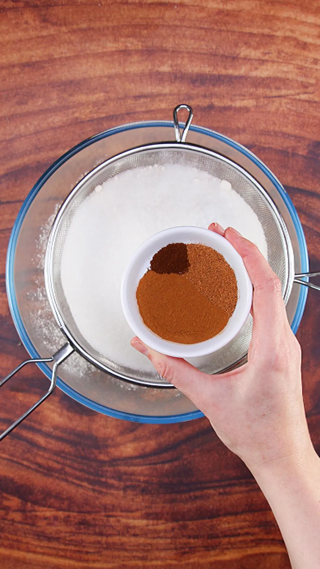 Dry ingredients being sifted into the large mixing bowl.