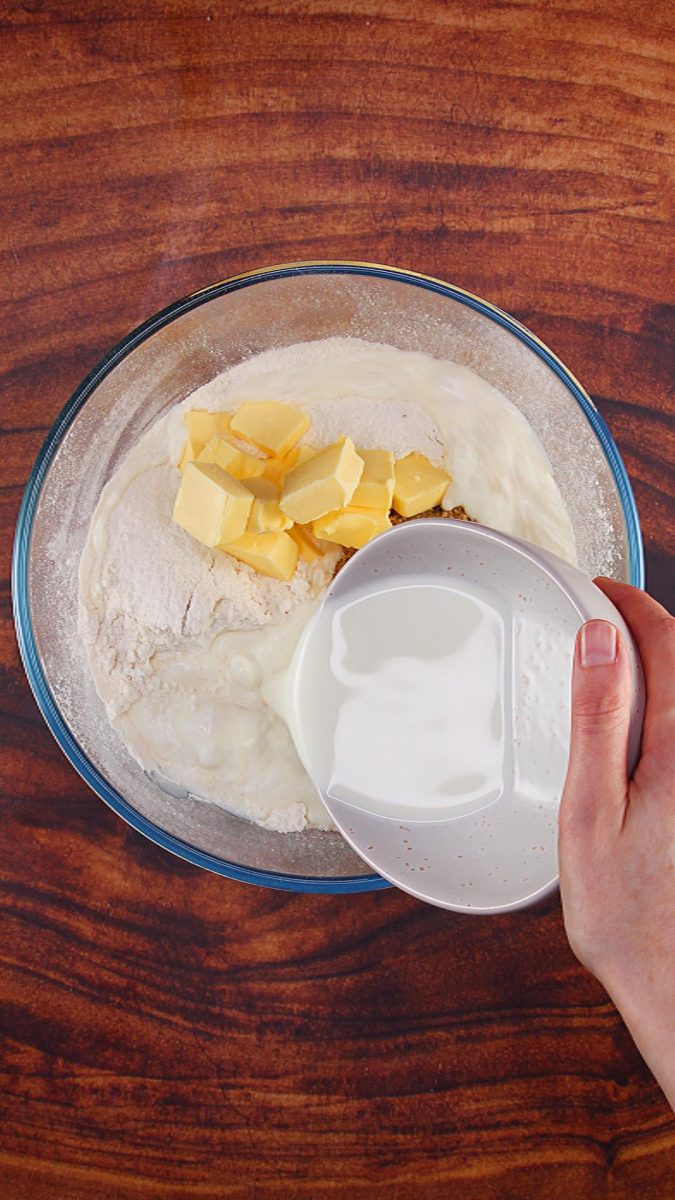 A bowl of buttermilk poured over butter and sugar in a bowl.