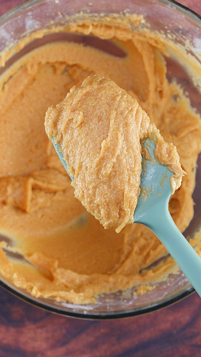 A spatula of thick peanut butter frosting. Hostess At Heart