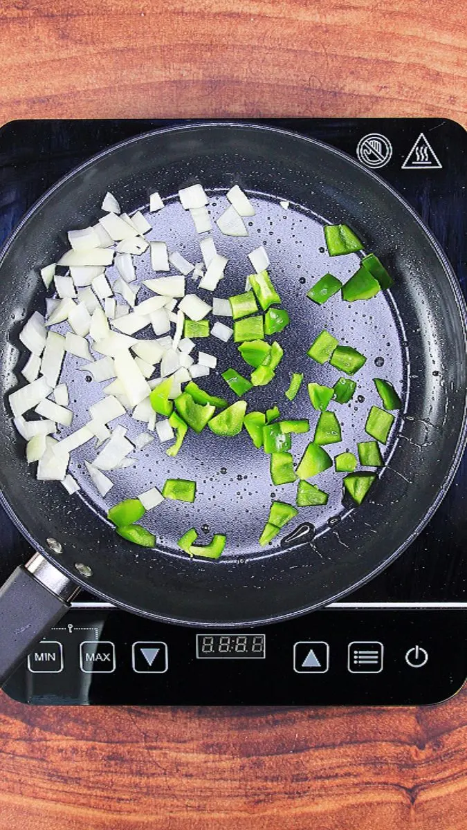 Diced onion and green pepper sauteing in a skillet - Hostess At Heart