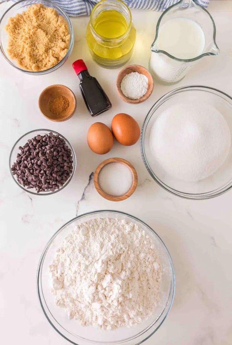 Ingredients for the Cappuccino Chocolate Chip Muffins: brown sugar, olive oil, milk, cinnamon, vanilla, salt, eggs, chocolate chips, white sugar, brown sugar, baking powder, flour, coffee. Hostess At Heart