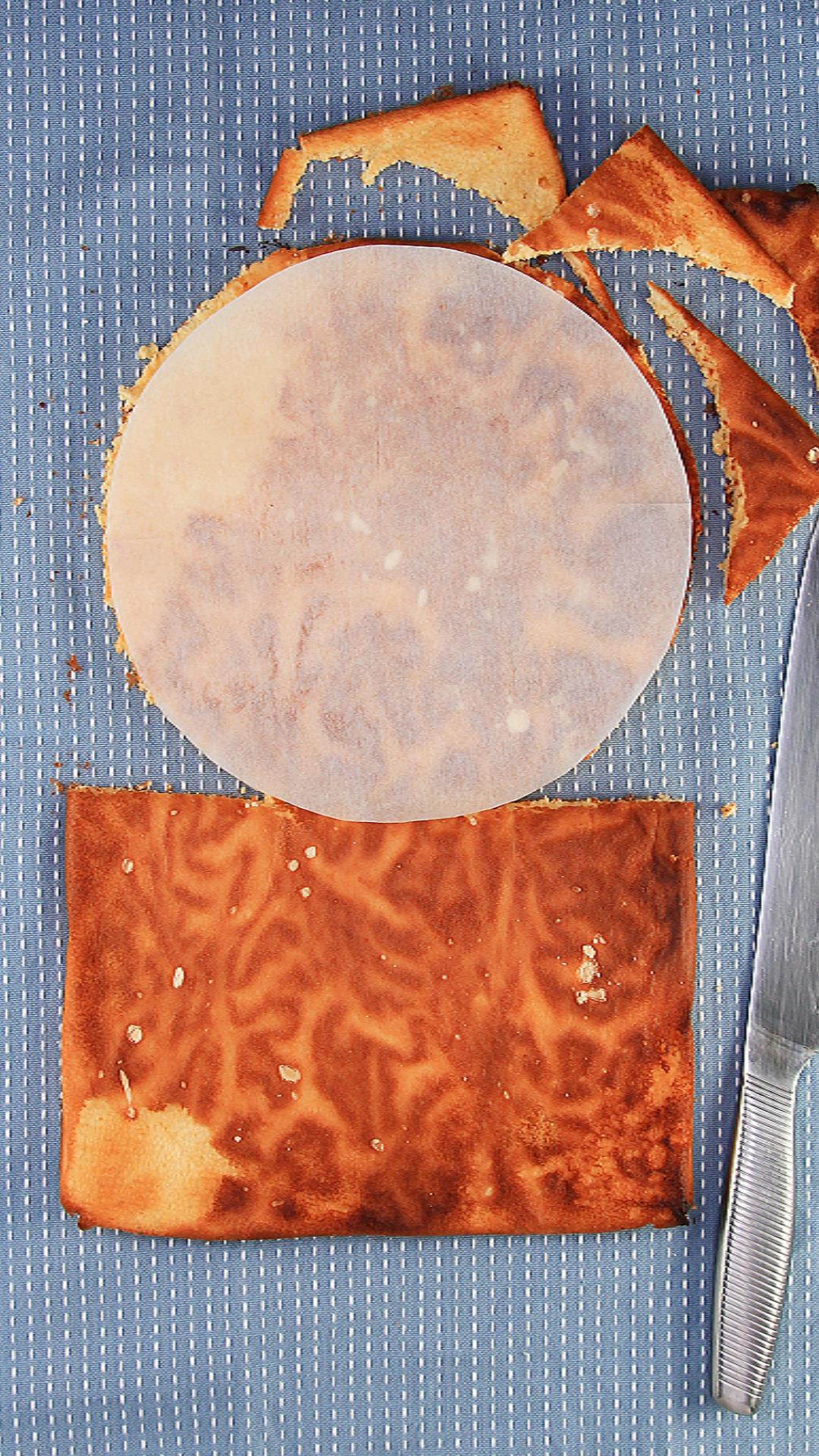 Cake cut into a circle using a parchment paper pattern.